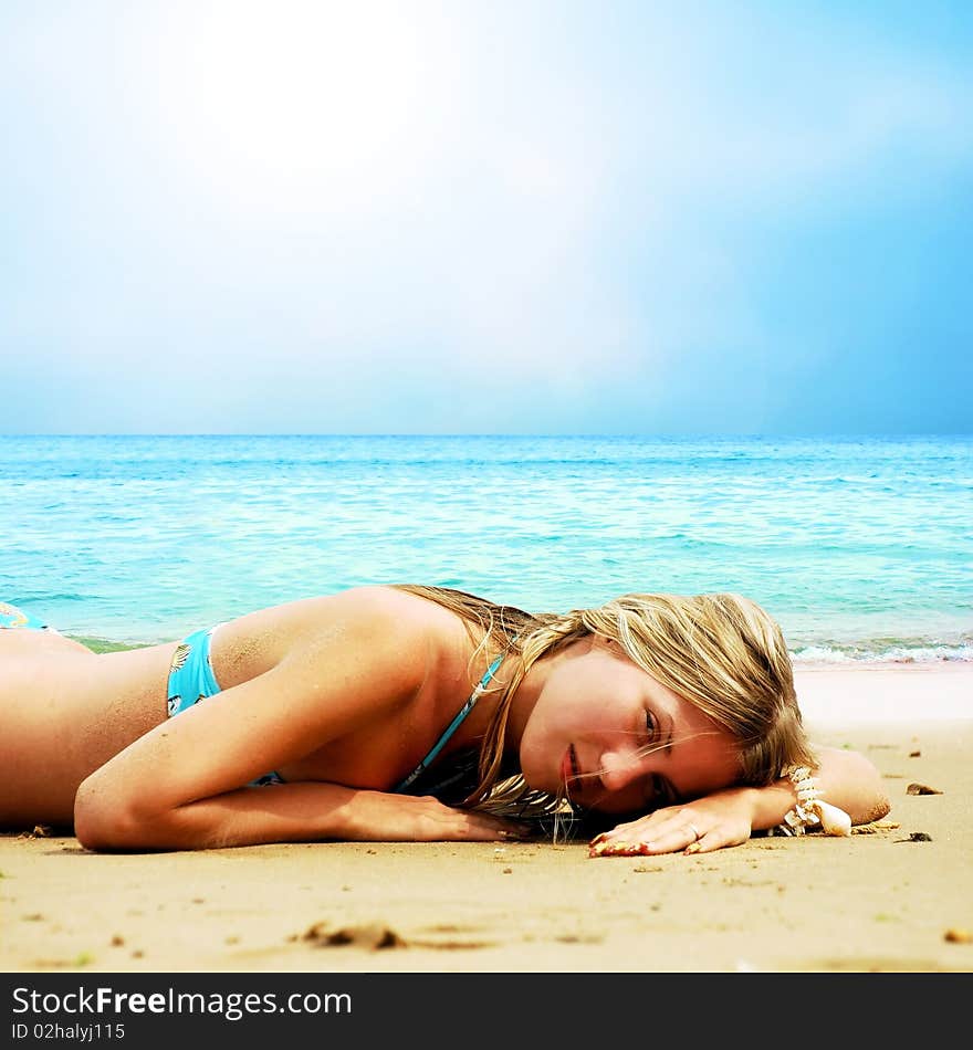 Young beautiful women on the sunny tropical beach in bikini. Young beautiful women on the sunny tropical beach in bikini