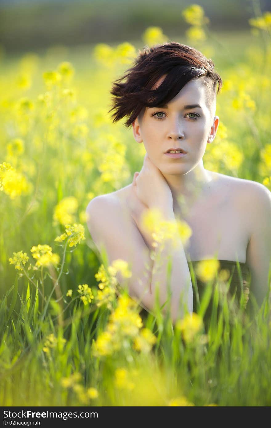 Young beautiful girl portrait on a green field. Young beautiful girl portrait on a green field.