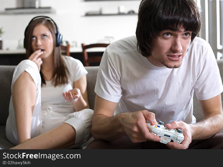 Girl with long hair and boy on sofa. Girl with long hair and boy on sofa