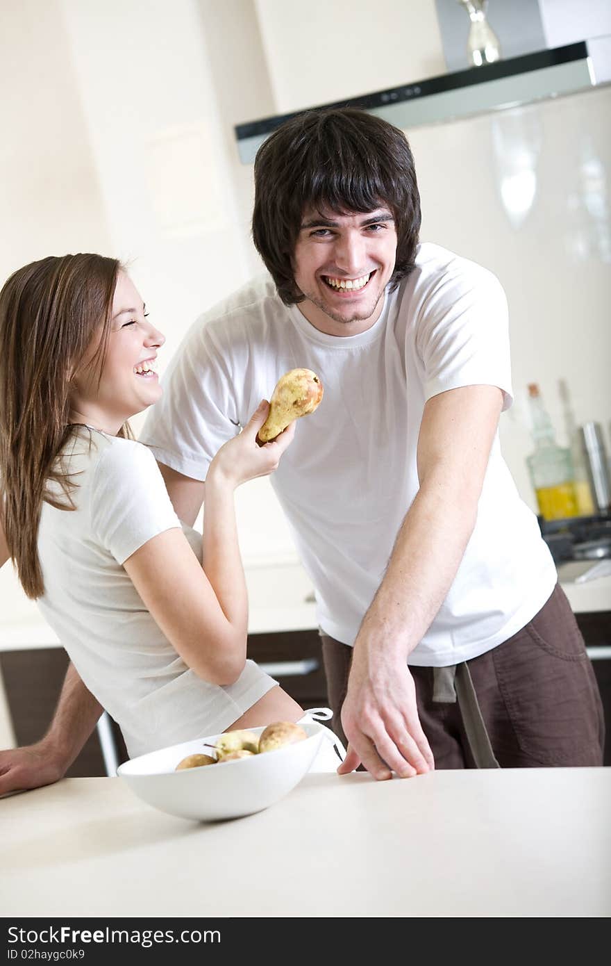 Nice long-haired girl with pear and boy with smile. Nice long-haired girl with pear and boy with smile