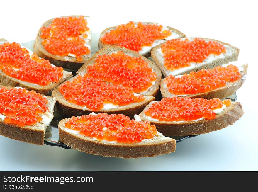 Bread with butter and red caviar on a plate. Bread with butter and red caviar on a plate