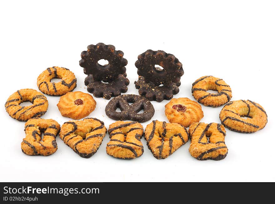 Biscuits of different forms of chocolate icing, against a white background. Biscuits of different forms of chocolate icing, against a white background