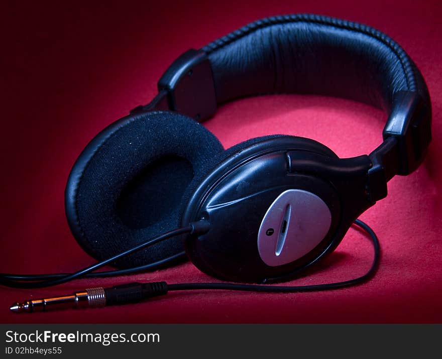 Black headphones on a red background