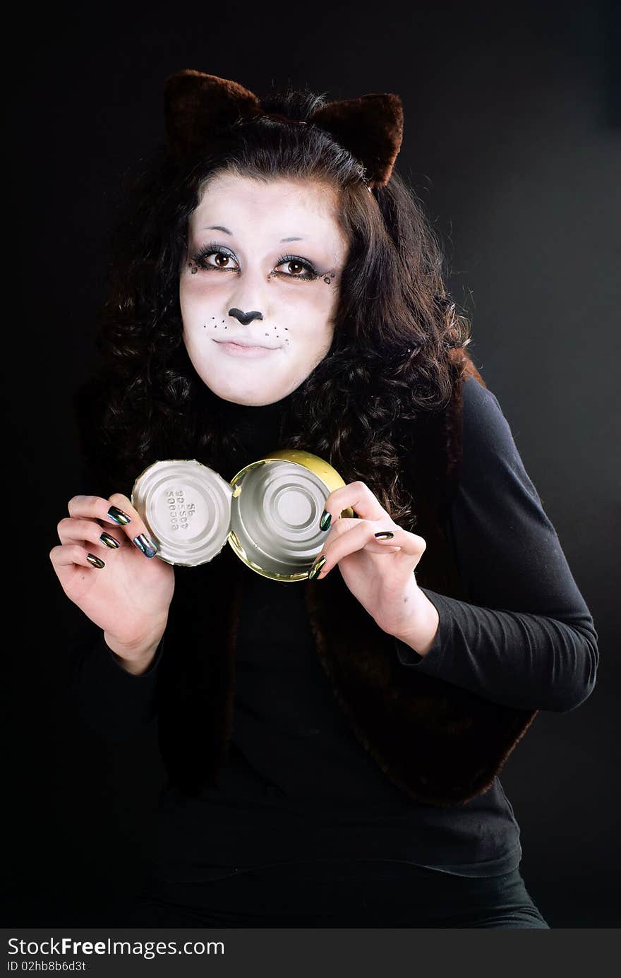 Portrait of a cat-girl with the can. Studio shot. Portrait of a cat-girl with the can. Studio shot.