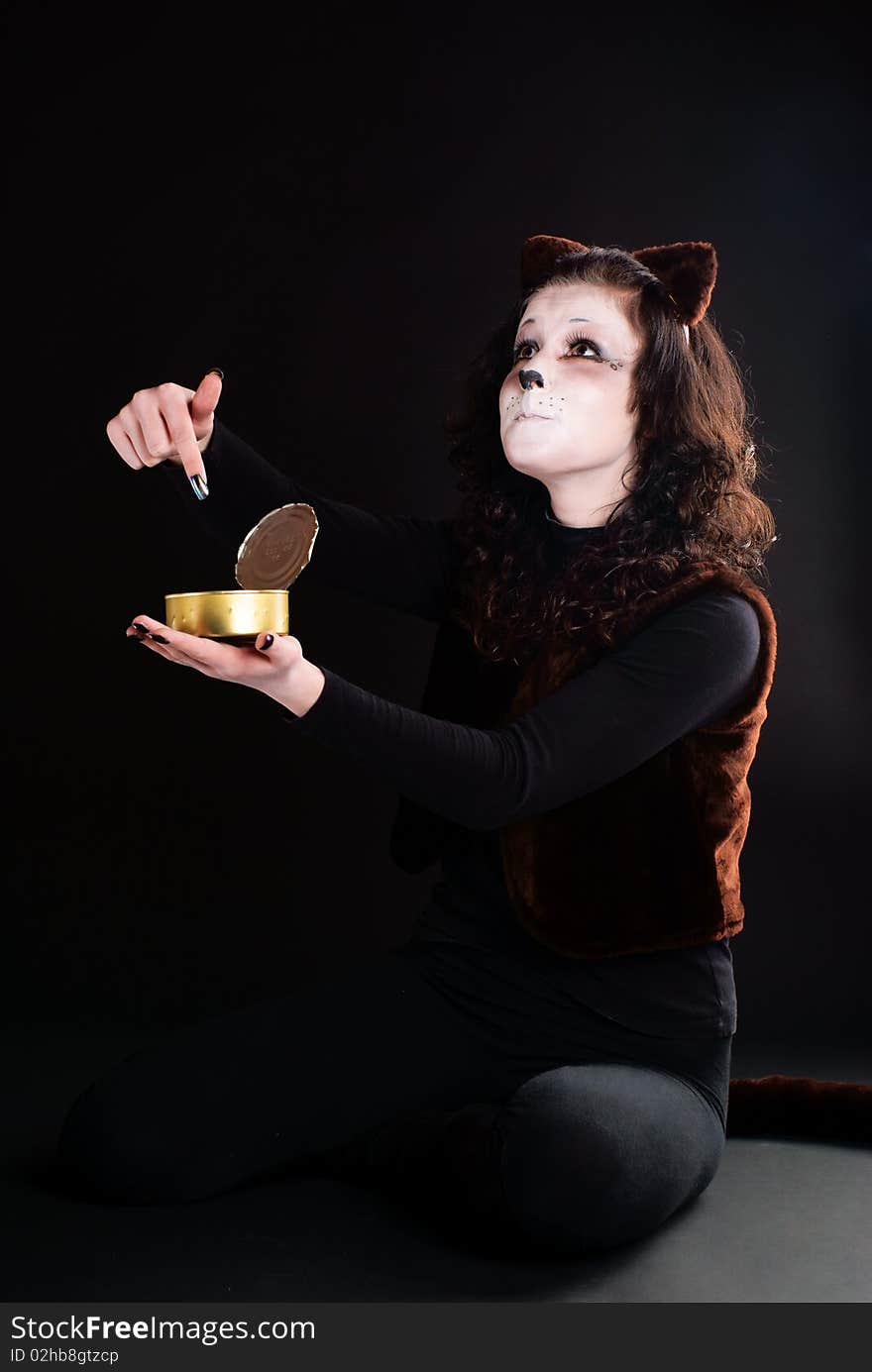 Portrait of a cat girl with an empty can. Studio shot. Portrait of a cat girl with an empty can. Studio shot.