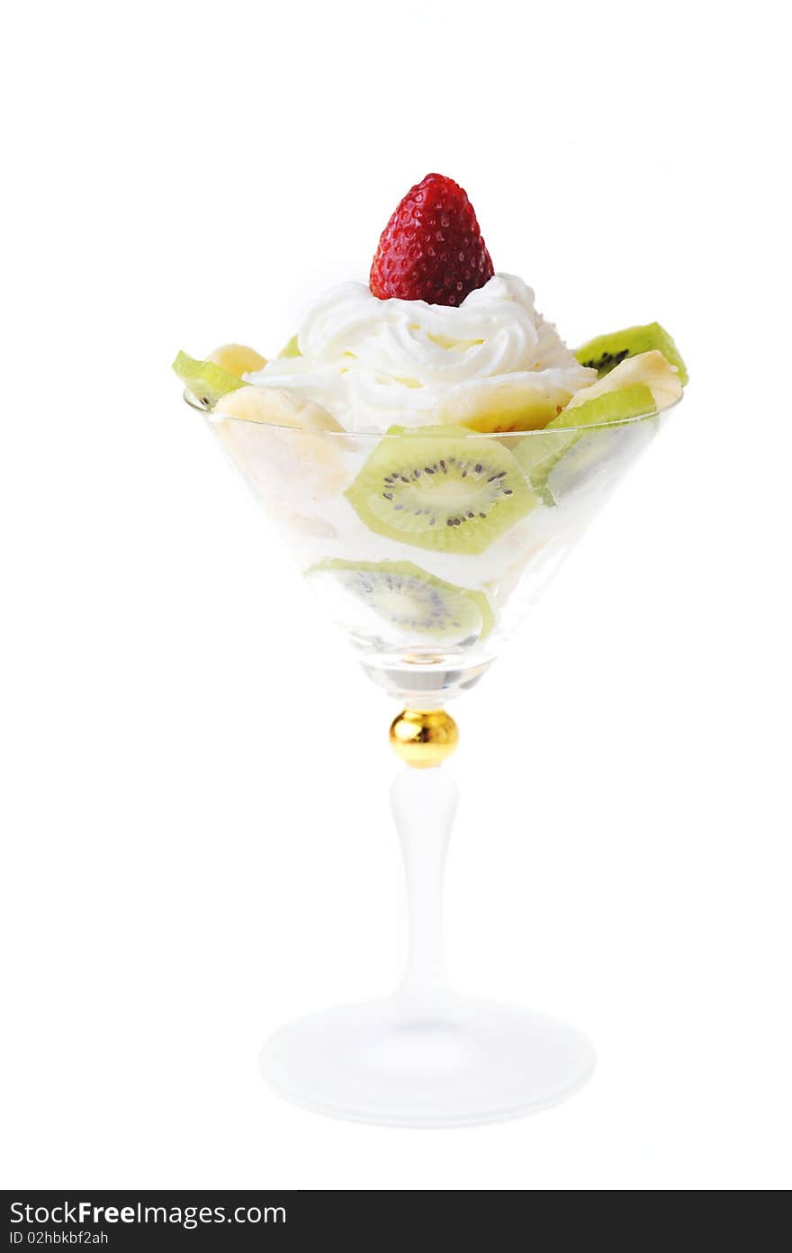 Fresh chopped strawberries, kiwi and banana with whipped cream in glasswares. Fresh chopped strawberries, kiwi and banana with whipped cream in glasswares