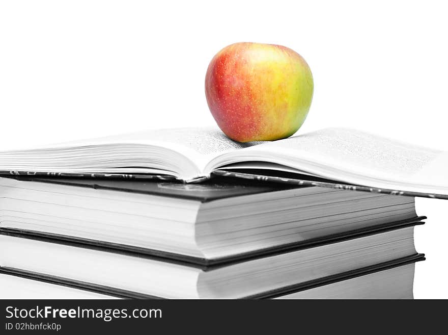 Red-yellow apple and open book isolated on a white background. Red-yellow apple and open book isolated on a white background.