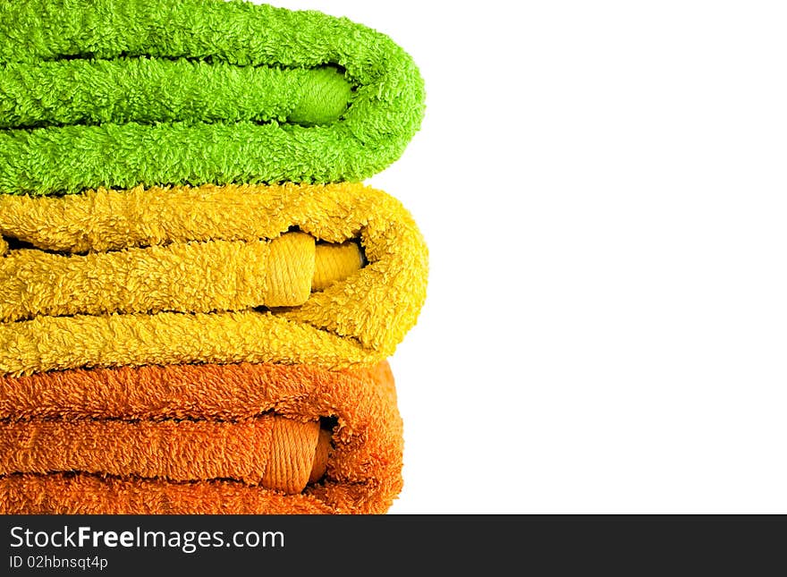 Stacked colorful towels isolated on a white background. Stacked colorful towels isolated on a white background.