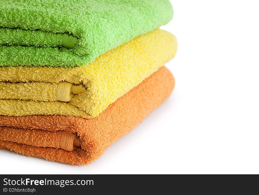 Stacked colorful towels isolated on a white background. Stacked colorful towels isolated on a white background.