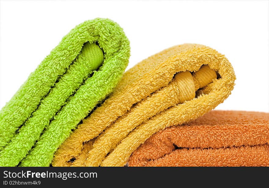 Stacked colorful towels isolated on a white background. Stacked colorful towels isolated on a white background.