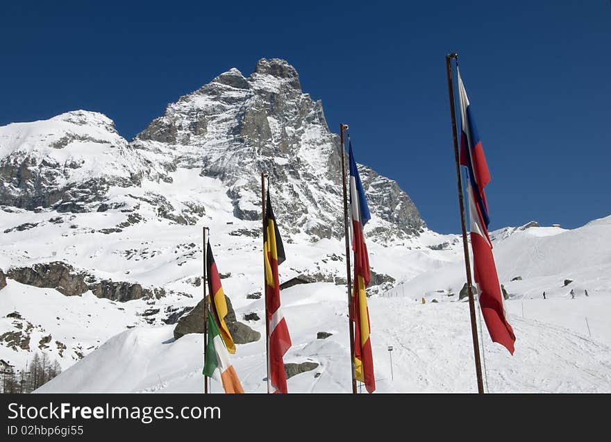 Picture of mount Cervino with international flags in a sunny day. Picture of mount Cervino with international flags in a sunny day