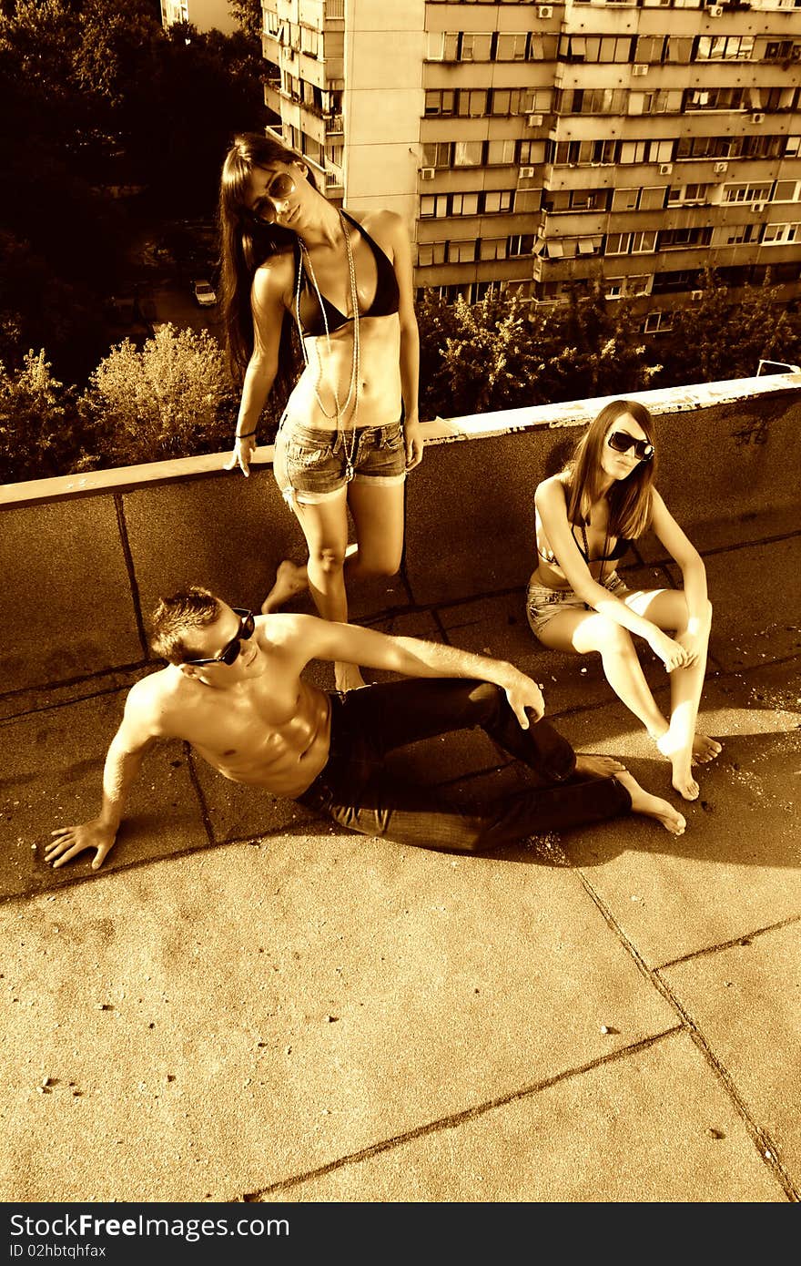 Young people chilling on the building roof. Young people chilling on the building roof.