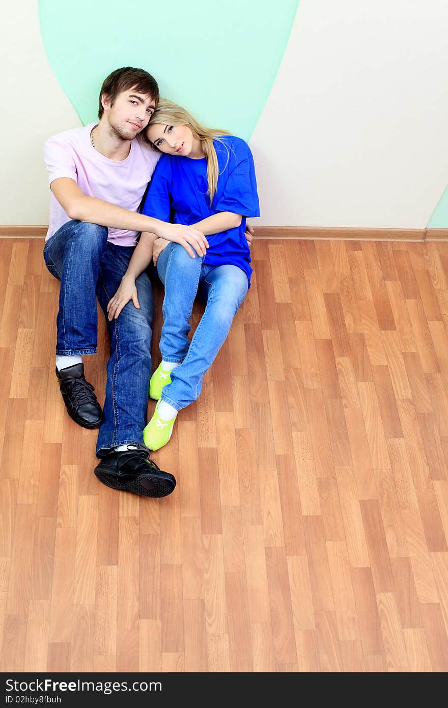 Happy young couple having a rest at their new home. Happy young couple having a rest at their new home.