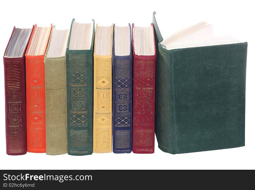 Some multi-coloured books on a white background