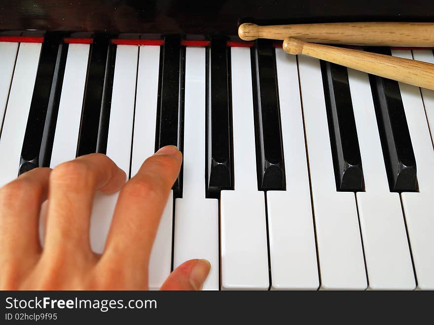 Left hand playing on piano keyboard