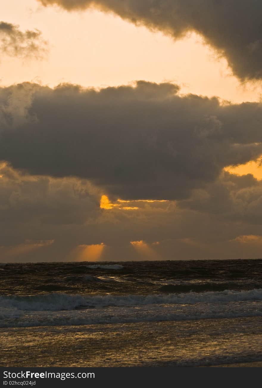 The sun setting off the coast of Florida in the Gulf of Mexico after a storm. The sun setting off the coast of Florida in the Gulf of Mexico after a storm