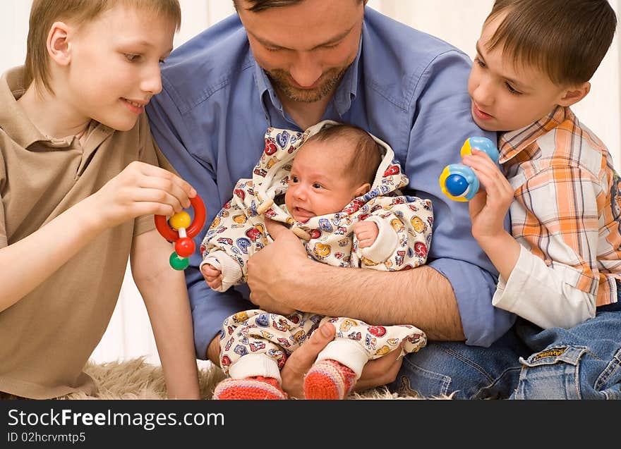 Happy dad plays with his three children. Happy dad plays with his three children