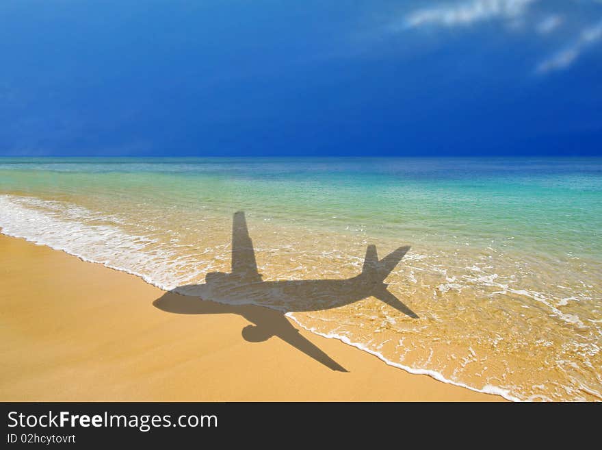 Shadow of plane over tropical beach. Shadow of plane over tropical beach