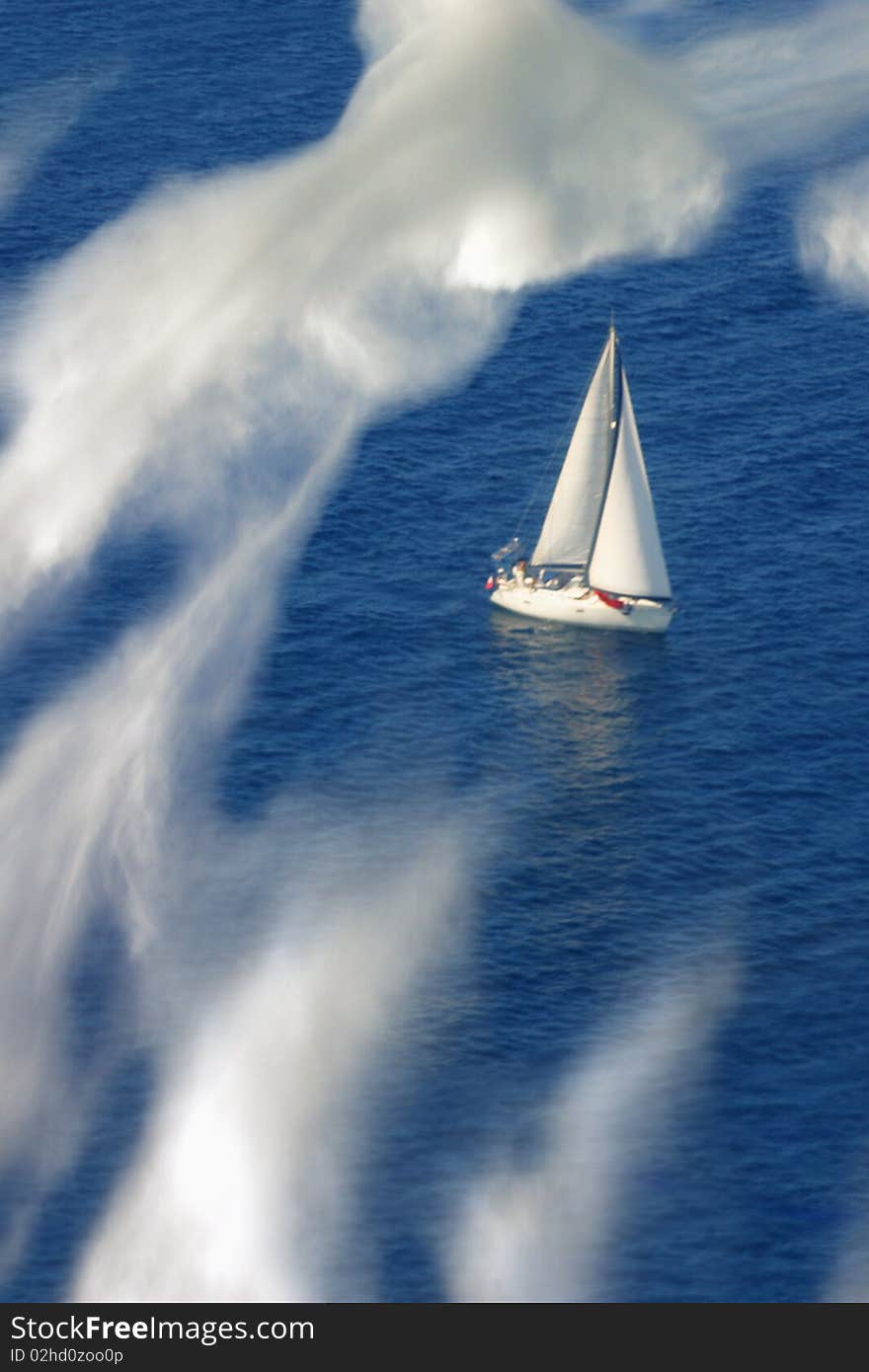 Mediterranean yacht seen through the clouds from an aeroplane. Mediterranean yacht seen through the clouds from an aeroplane