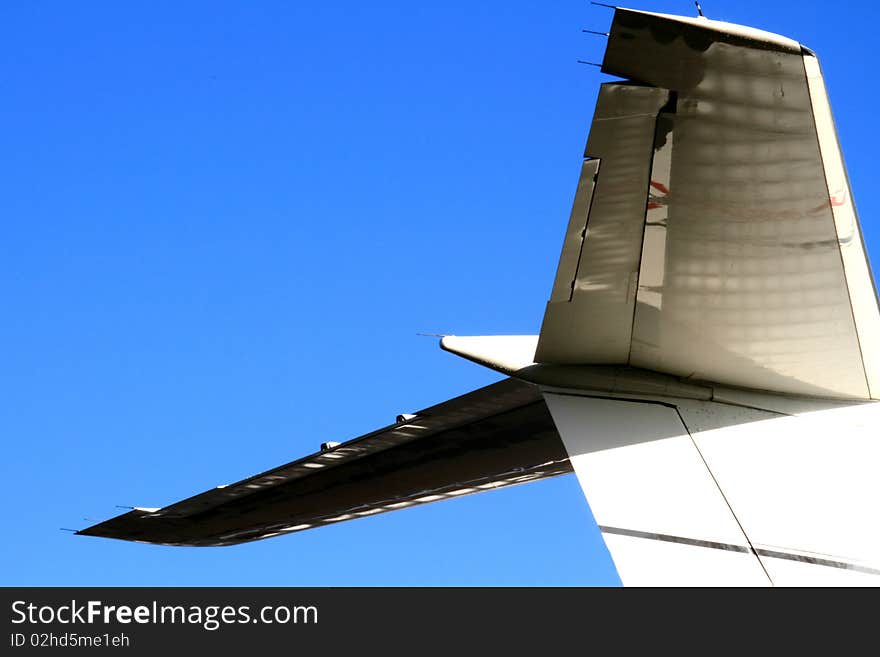 Airplane tail on runway with blue background sky stock photo. Airplane tail on runway with blue background sky stock photo