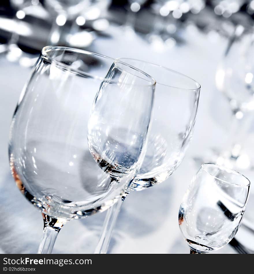 Three glass goblets on white table