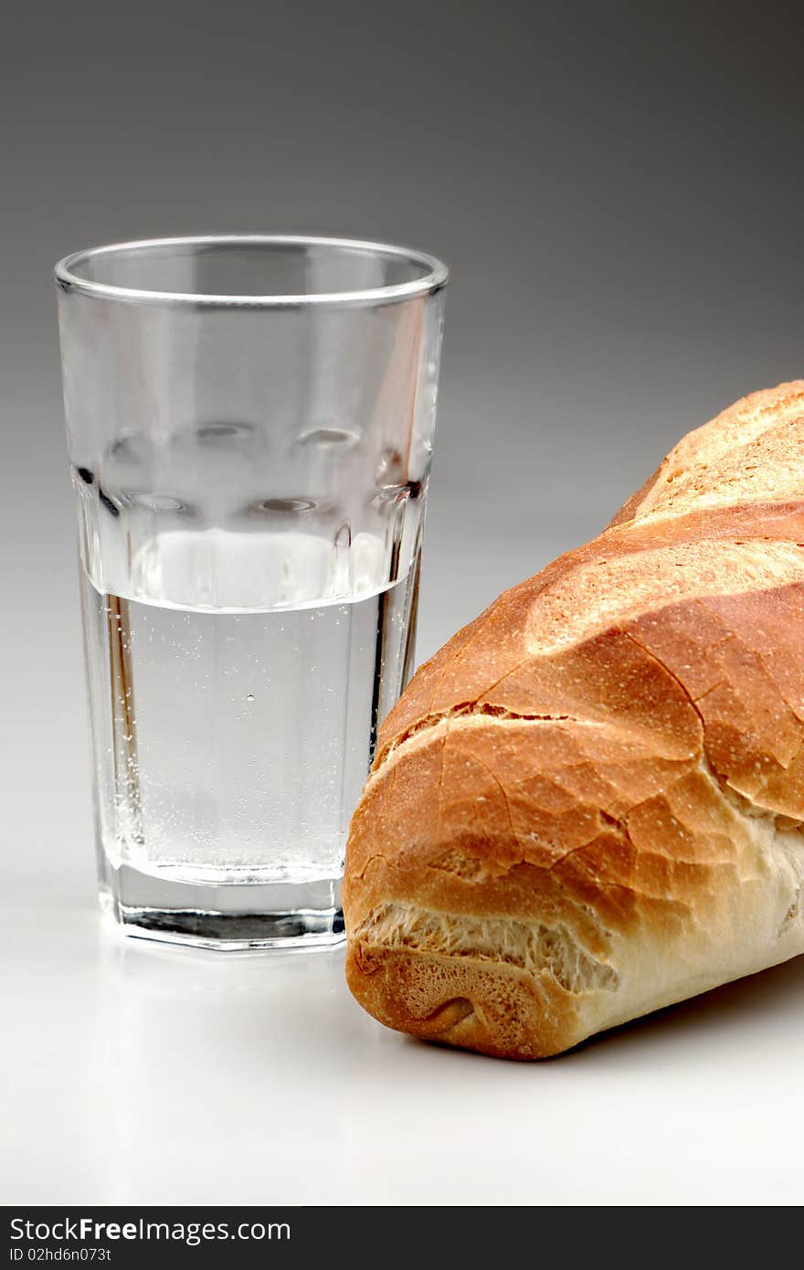 Piece of bread with glass of water