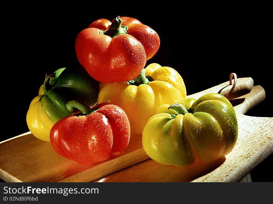 Colourful peppers on chopping board. Colourful peppers on chopping board