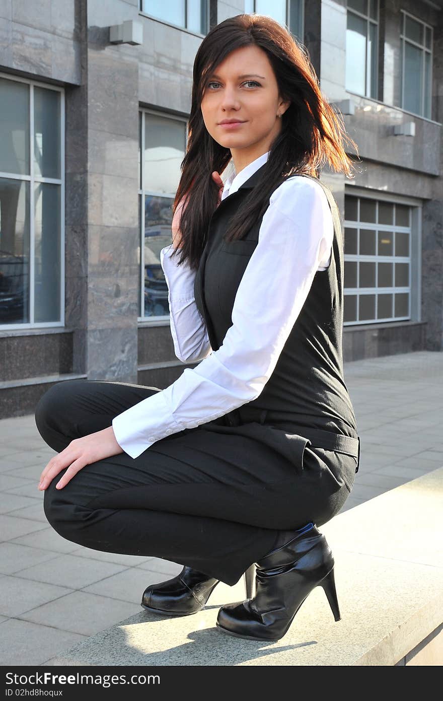 The business woman sits nearby centre business in a business suit