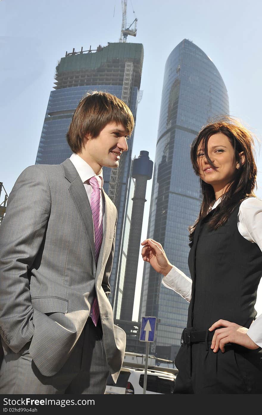 Two businessmen discuss the project against a skys