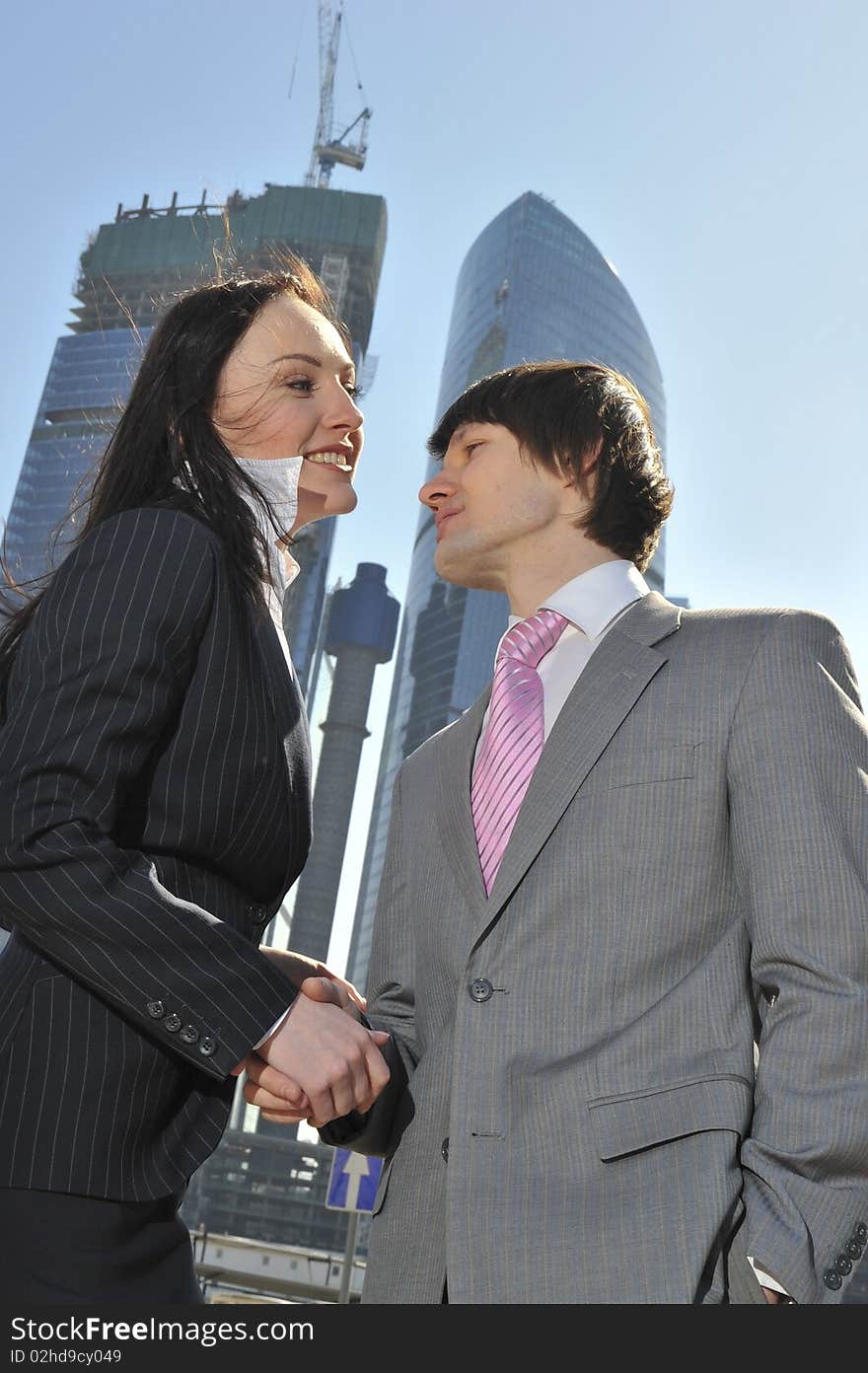 Two Businessmen Discuss The Project Against A Skys