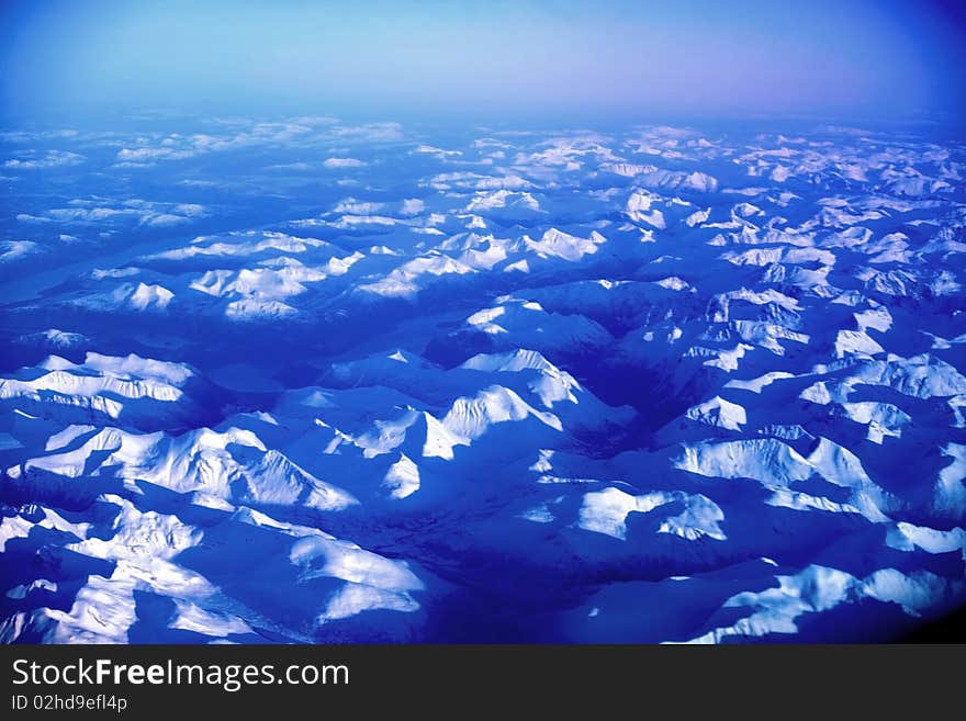 Sundown over the mountains covered in snow