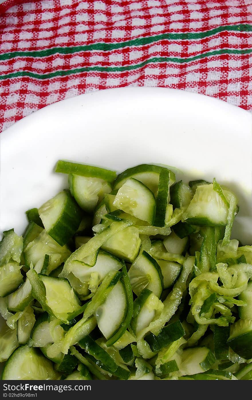 Green small cucumber sliced and grated in bowl