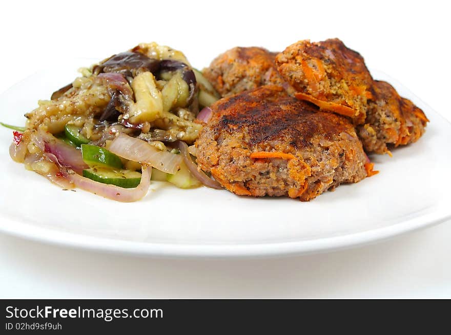 Rissole and egg plant with cucumber salad dinner on plate. Rissole and egg plant with cucumber salad dinner on plate