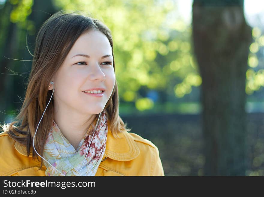 Young woman walking and listnening music. Young woman walking and listnening music