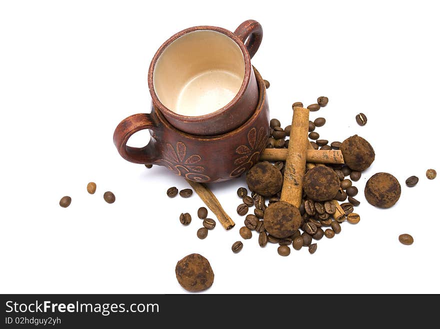 Cups and coffee beans isolated on white background