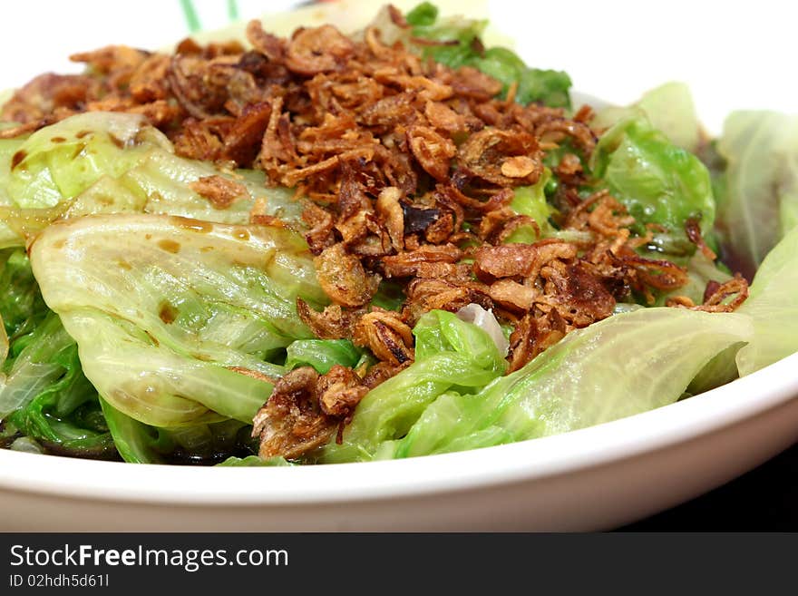 Fresh steamed vegetables with cut deep fried onions.