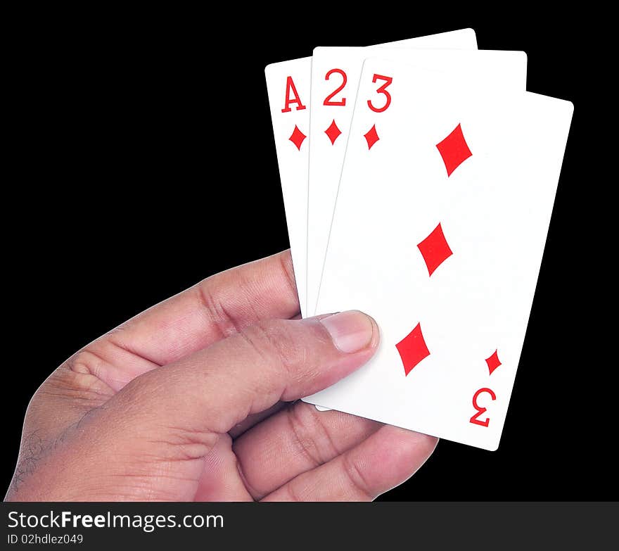 Hand with playing cards in black background