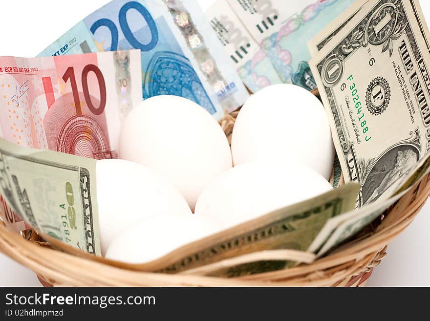 Eggs with money in basket isolated on white background. Financial concept. Eggs with money in basket isolated on white background. Financial concept.