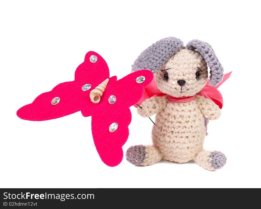 Knitted toy. Hare with butterfly