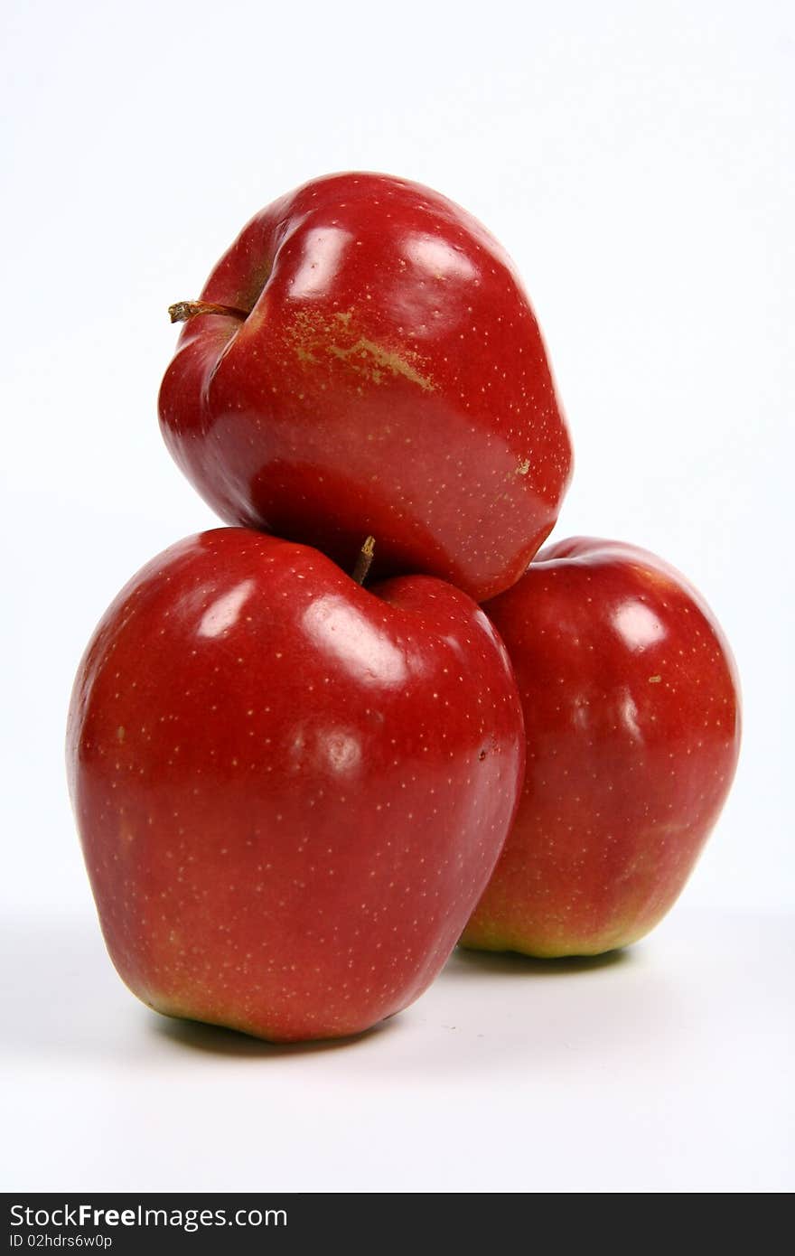 Three red apples on white background