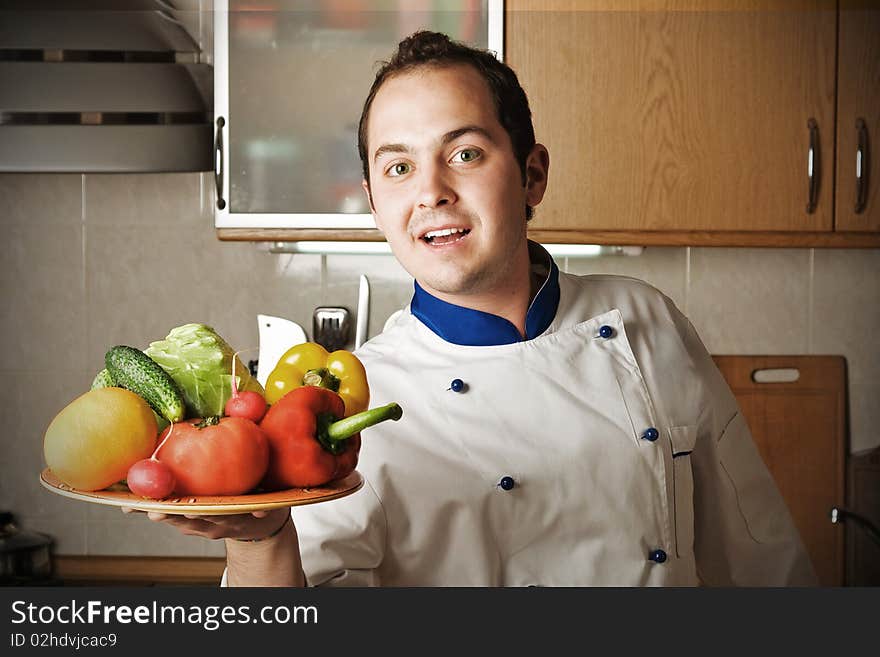 Happy Man With Vegetables On Kitchen