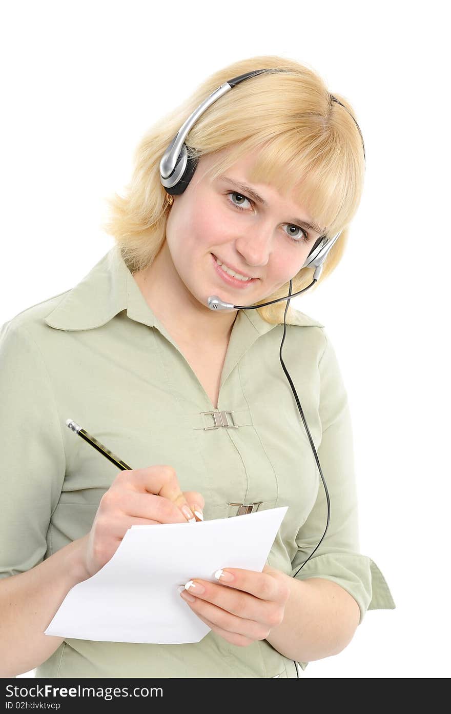 Beautiful young woman in headphones, with a pencil and a paper smiles on a white background. Beautiful young woman in headphones, with a pencil and a paper smiles on a white background