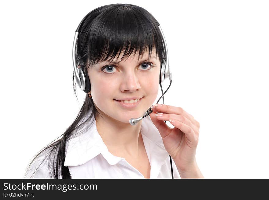 Beautiful young woman in headphones smiles in current of telephone conversation on a white background. Beautiful young woman in headphones smiles in current of telephone conversation on a white background