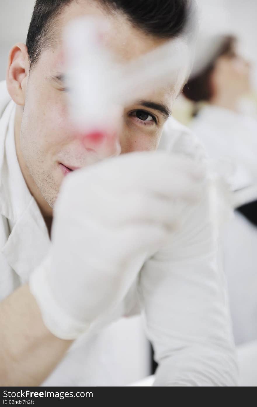 Young man scientist in chemistry bright lab. Young man scientist in chemistry bright lab