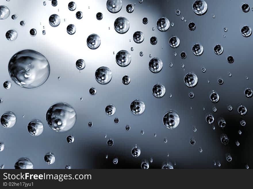 Beautiful and clean water droplets on reflective surface.