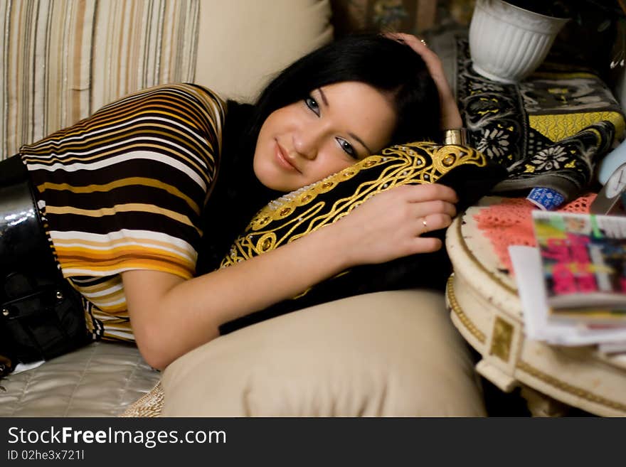 Young beautiful girl lying on couch. Young beautiful girl lying on couch