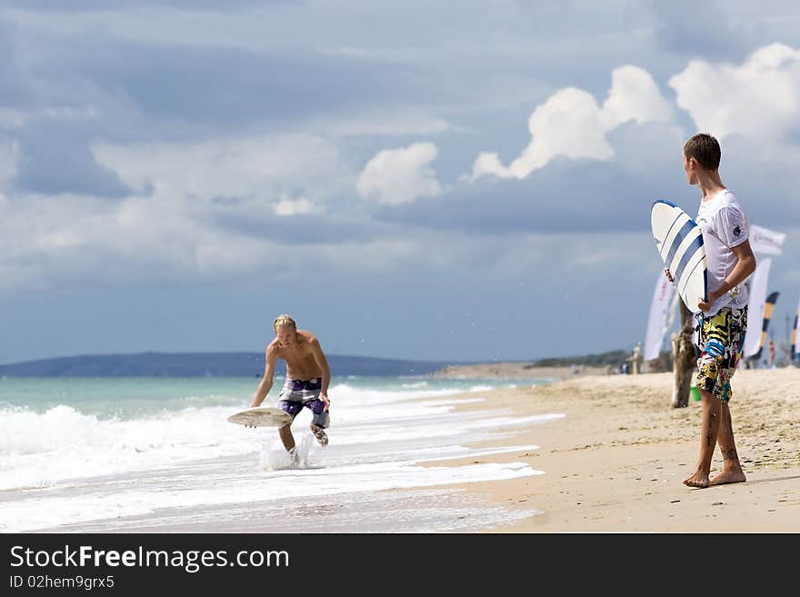 Two yong surfer riding on coastal waves