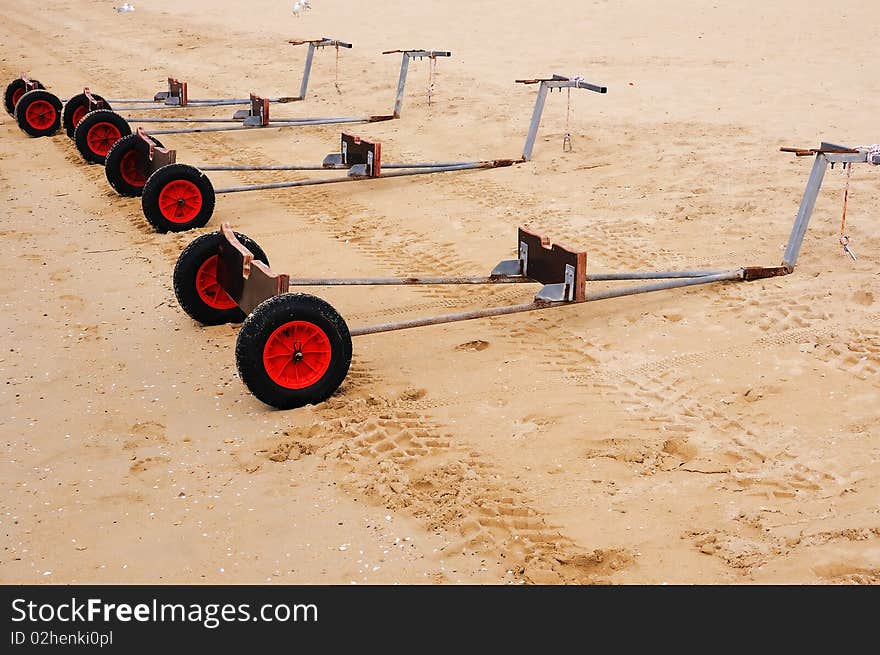 Truck for yachts on the sandy beach as a symbol of teamwork