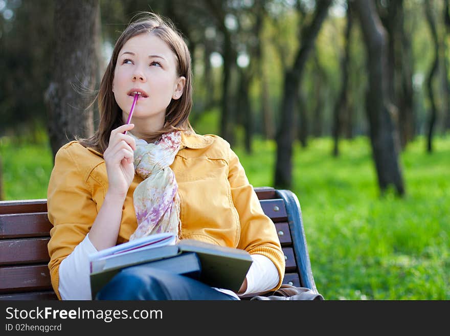 Woman With Book In Park