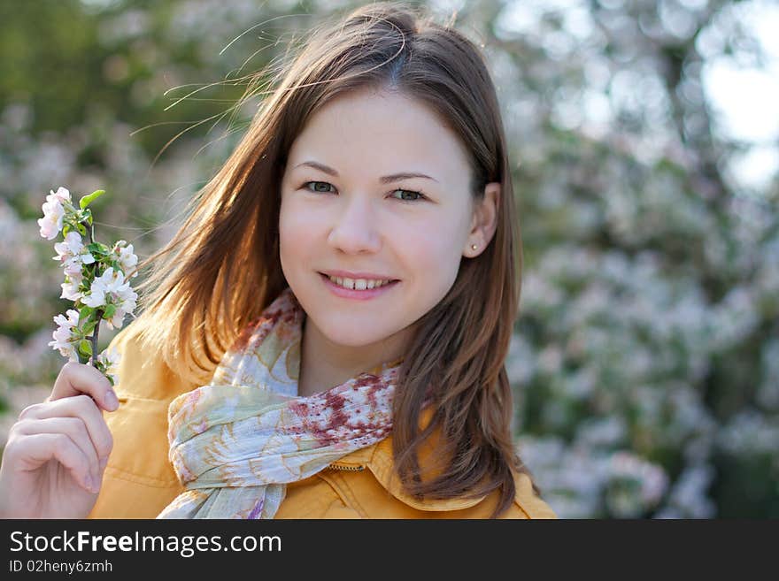 Young woman in blooming park